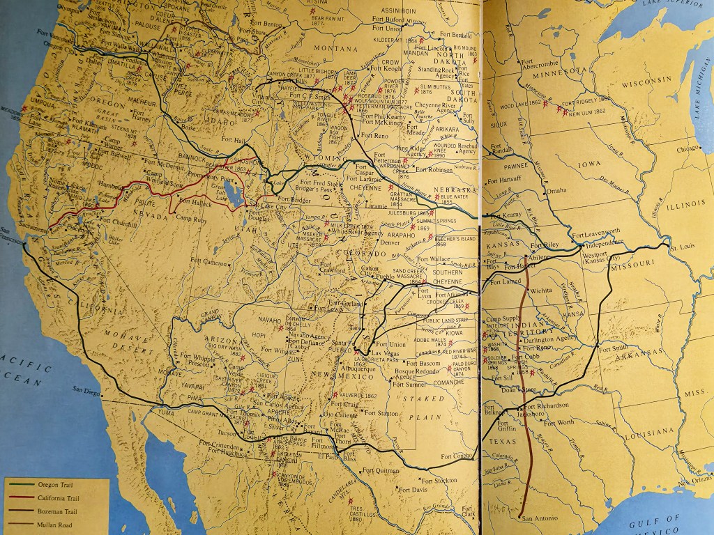 A historical map of the western United States, highlighting important trails such as the Oregon Trail, California Trail, Bozeman Trail, and Mullan Road, with marked forts and geographical features.